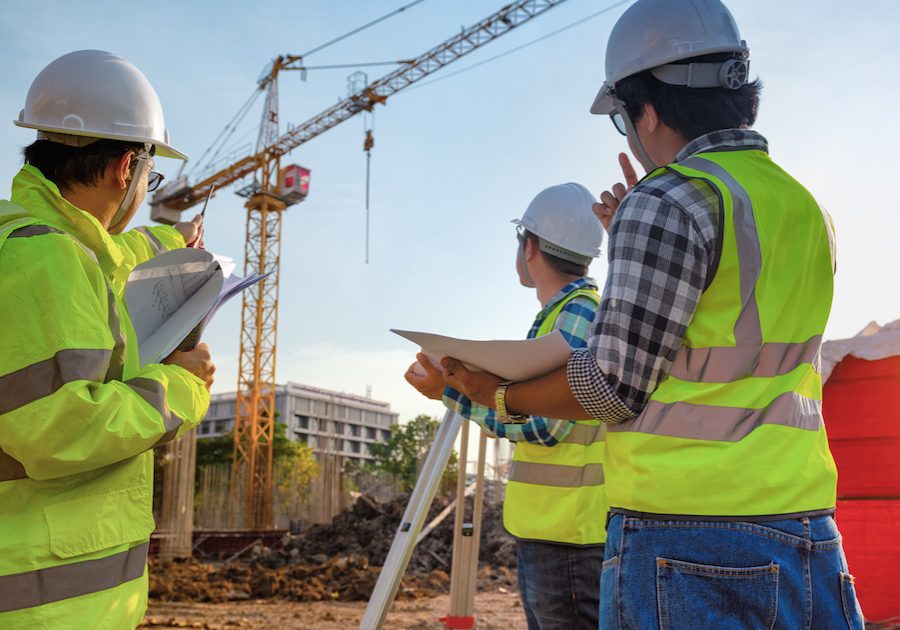 Construction engineers discussion with architects at construction site or building site of highrise building with Surveying for making contour plans is a graphical representation of the lay in land.